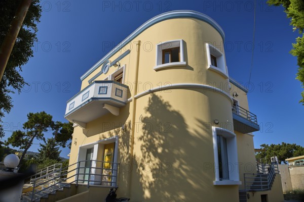 Modern yellow house with curves and balcony surrounded by trees, Armando Bernabiti, Historicism,