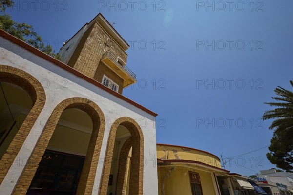 Market hall, Agora, Clock tower in clear style with arches and yellow elements, impresses in the