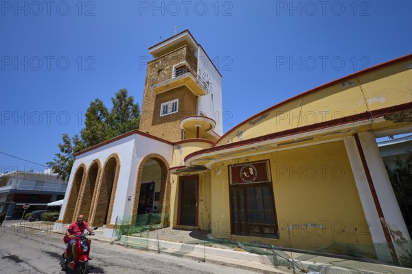 Market hall, Agora, Historical building with clock tower and arches, animated by people and trees