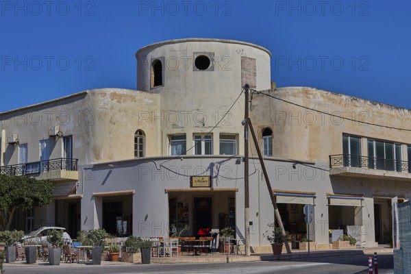 Municipal office, Farmazie, Corner building with round tower, café and open windows on a busy
