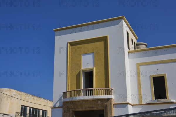 Modern building with geometric design and clear edges under a clear blue sky, Armando Bernabiti,