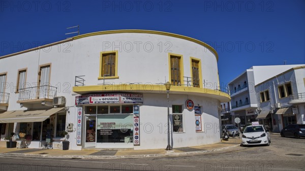White corner building with shops and parked cars on the street, Armando Bernabiti, Historicism,
