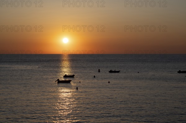 Boats in front of sunset at the sea, North Sea, English Channel, Étretat, evening mood,