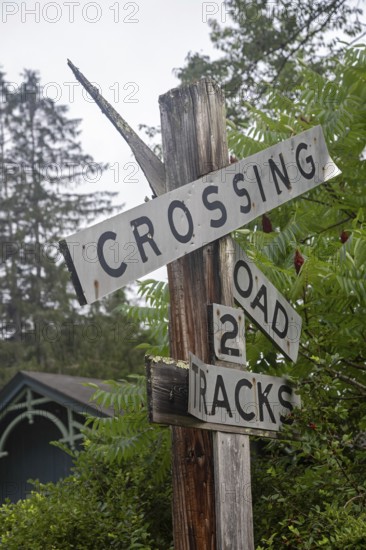 Clover Lick, West Virginia - An old railroad crossing sign stands next to the Greenbrier River