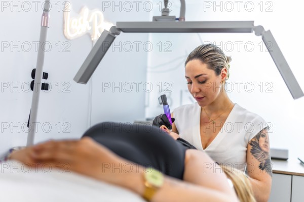 Beautician performing a professional permanent makeup treatment on a client's eyebrows, using a