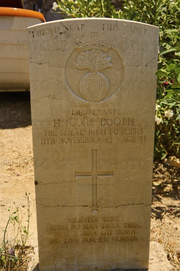 Gravestone of a soldier with cross and inscription in warm light, Hugh Gore-Booth, Irishman,
