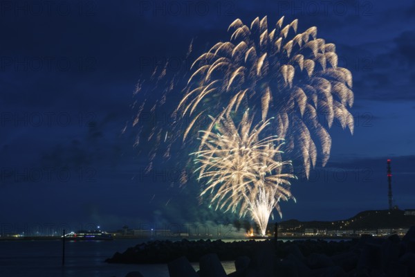 Radiant luminous colours, atmospheric fireworks in green and gold, Heligoland island festival,