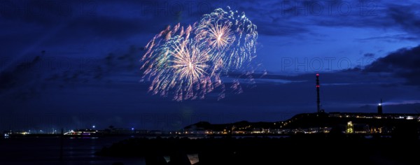 Radiant luminous colours, atmospheric fireworks in red, green and gold, Heligoland island festival,