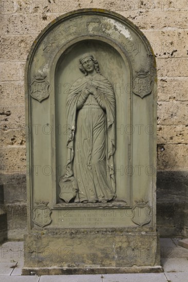Old gravestone in front of St Martin's Church, catholic church, graceful female figure, relief,