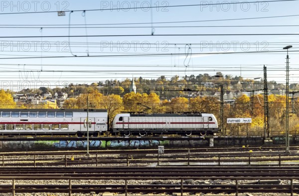 InterCity entering Stuttgart Central Station in autumn. Apron with station sign. Stuttgart,