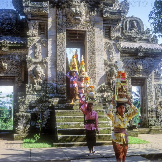 Temple festival, woman wearing traditional costumes, Gebogan, offerings piled up up to pyramids,