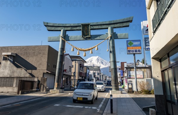 Cars drive through the city, Grand Torii Gate across a street, street scene, Mt. Fuji, Fujiyoshida,