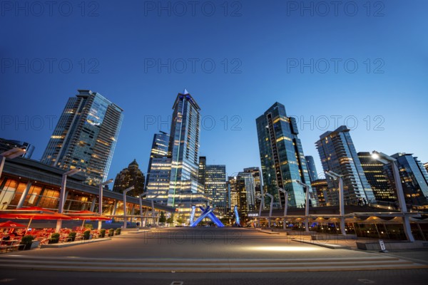Illuminated skyscrapers on the promenade in the evening, Olympic Cauldron Statue, Jack Poole Plaza