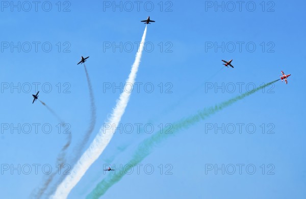 The Indian Air Force (IAF) Surya Kiran aerobatics team performs during an air show as part of the