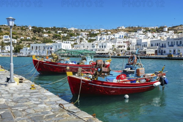 Mykonos, Cyclades, Greece - Colourful fishing boats are moored on the quay in the old port of