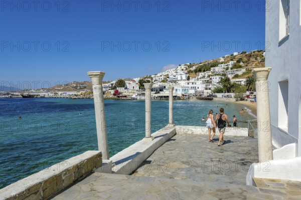 Mykonos, Cyclades, Greece - Tourists and locals like to bathe at the small town beach Paralia