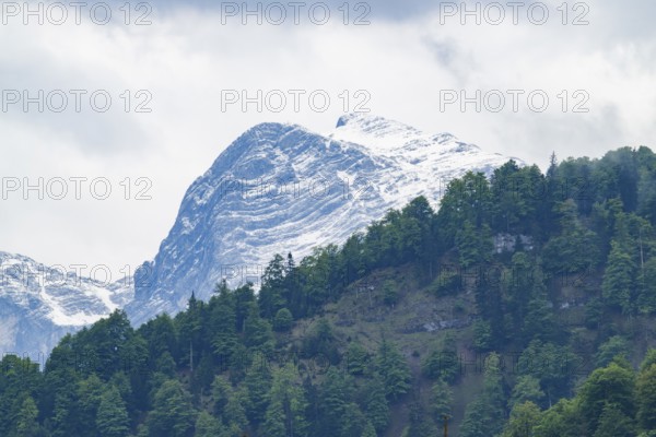 View into the mountains next to Lake Almsee on a rainy day in spring, Traunstein summit,