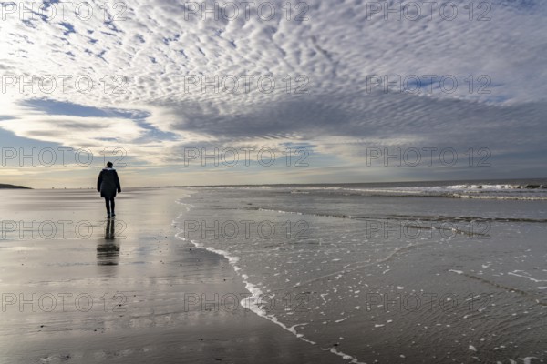 Walkers on the Wadden Sea near the East Frisian island of Spiekeroog, west of the North Sea island,