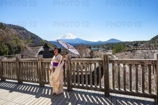 Japanese woman in kimono with umbrella, Iyashinosato open-air museum, old Japanese village with