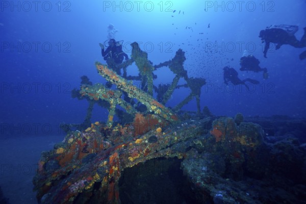 Divers explore a paddle wheel covered with sea sponges in the Mediterranean near Hyères, Wreck