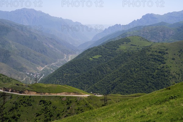Panoramic view of a valley with road and green hills between mountains, view of Lernadzor