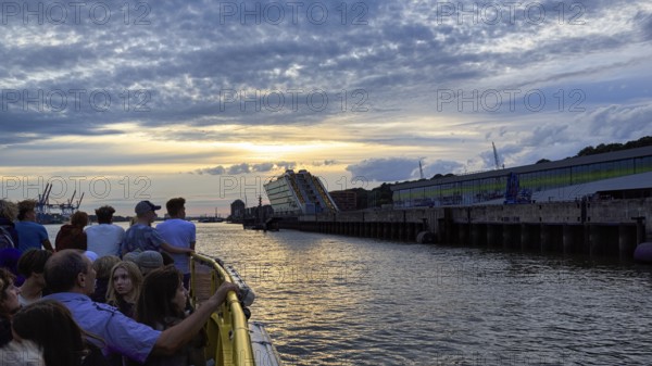 Harbour ferry line 62 with passengers on the Elbe, harbour cruise at sunset, Docklands, Hamburg,