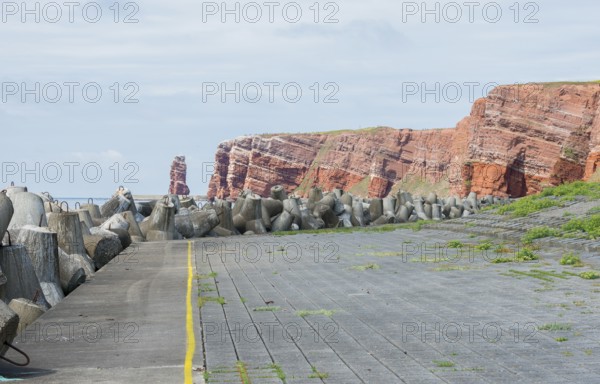 Coastline with concrete tetrapods by the sea, coastal protection, protective wall, paved coastal