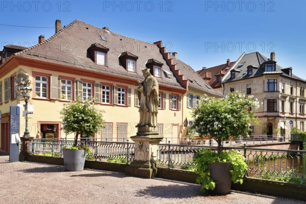 Ettlingen, Germany - August 13th 2025: Statue of Saint John of Nepomuk on Rathausbrücke bridge over