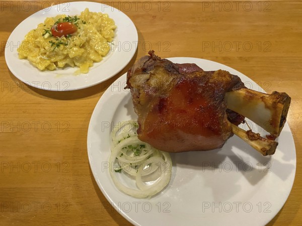 Crispy fried pork knuckle with crust, potato salad, onions, on table, food, Stuttgart,