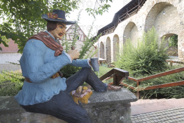 Sculpture of sitting irregulars with historical clothing at picnic, partisan eating, partisan,