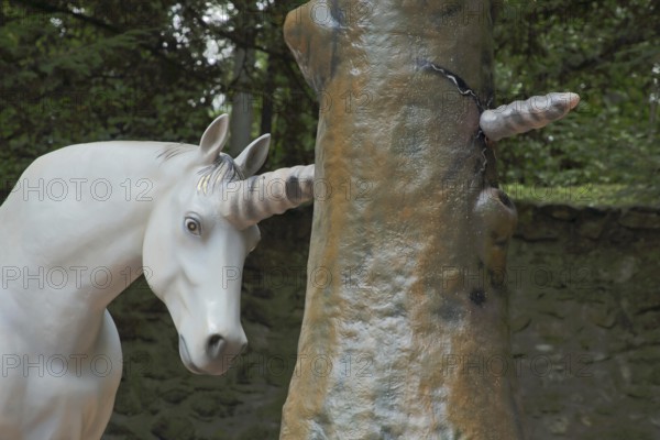 Horn of a unicorn in fairy tale The brave little tailor forcefully pierces a tree trunk, sculpture,