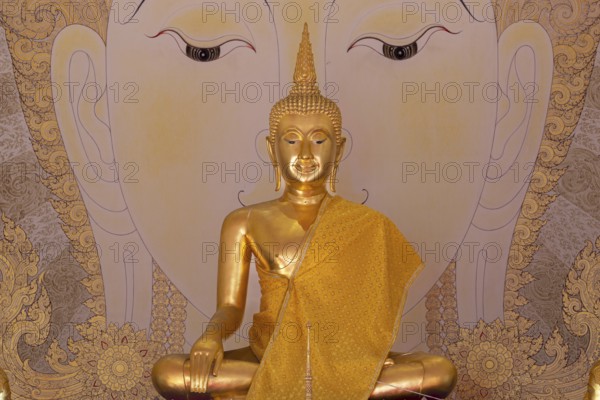 Golden Buddha statue with tunic, Bhumispara mudra, Buddha Gautama at the moment of enlightenment,
