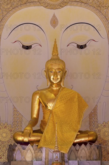 Golden Buddha statue with tunic, Bhumispara mudra, Buddha Gautama at the moment of enlightenment,