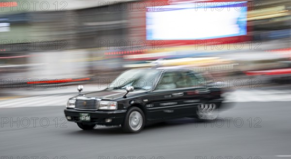 Black taxi driving, motion blur, long exposure, Shubuya Crossing, Shibuya, Tokyo, Japan