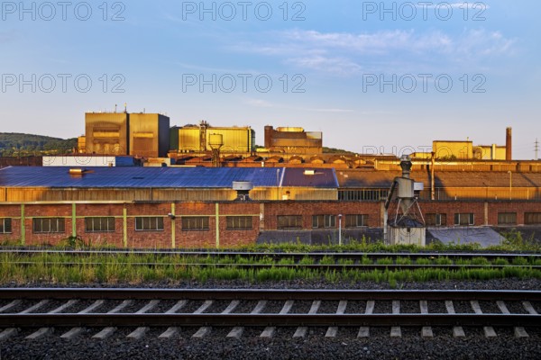 Deutsche Edelstahlwerke with train tracks at sunrise, central railway station, Witten, Ruhr region,