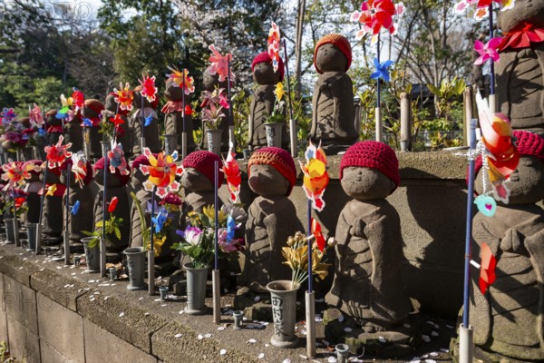 Jizo statues with red crocheted caps, guardian deities for deceased children, Unborn Children