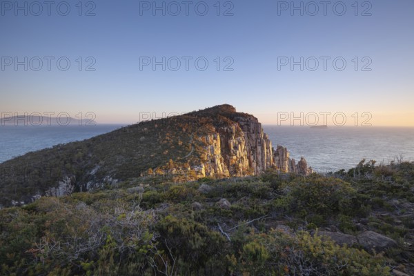 Sunrise hiking trail over the dramatic cliffs of Cape Hauy, Tasman Peninsula, Tasmania, Australia