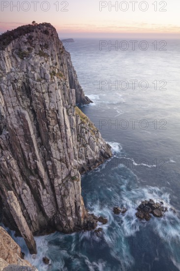 The Lanterns and Totem Pole Long exposure at sunrise shows glowing dawn over the dramatic cliffs of