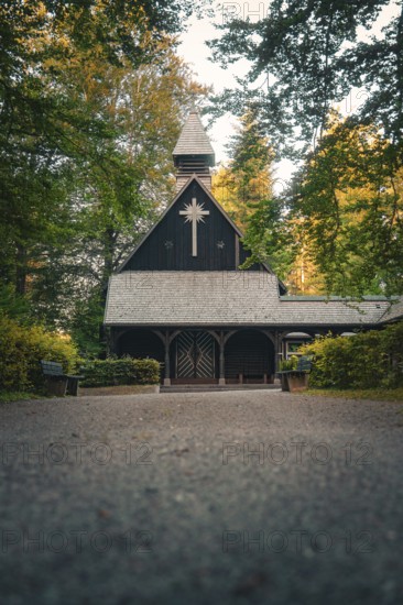 Wooden church in the forest, surrounded by trees in an atmospheric evening atmosphere, Altensteig,