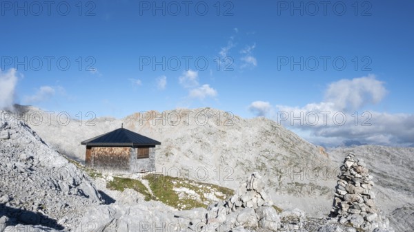 The Wildalmkirchl bivouac, a bivouac hut or bivouac box in the Steinernes Meer, with a large stone