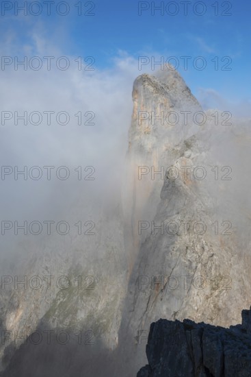 Summit of Wildalmkirchl with steeply sloping rock face surrounded by clouds, Steinernes Meer,