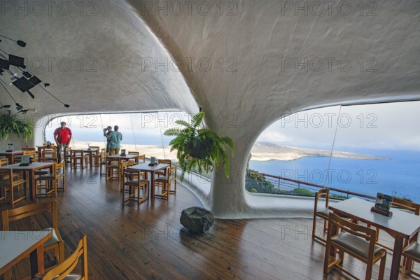 Interior of café with panoramic window in building designed by Cesar Manrique with the
