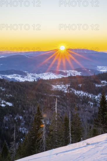 Sunrise over the hills of czech republic from Mount Lusen wth the view over the hills of the