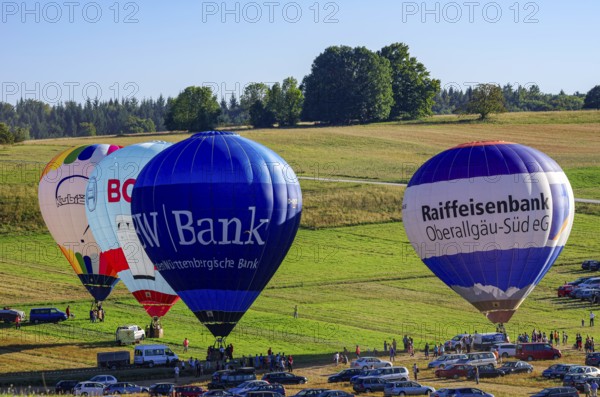 Hot air balloons are being prepared for takeoff as part of an air show at the Fliegerbergfest of