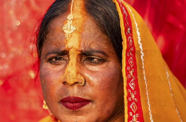 A Hindu devotee offer prayers to the Sun God on the bank of Brahmaputra river on the occasion of