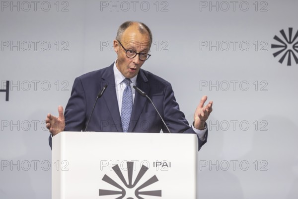 Federal Chancellor Friedrich Merz (CDU) . Portrait at the lectern with free text space.