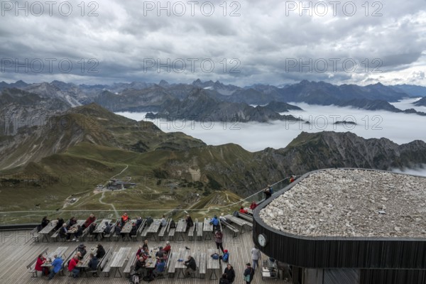 Restaurant at the Nebelhorn summit with views of the Allgäu Alps, mountains rising from fog in the