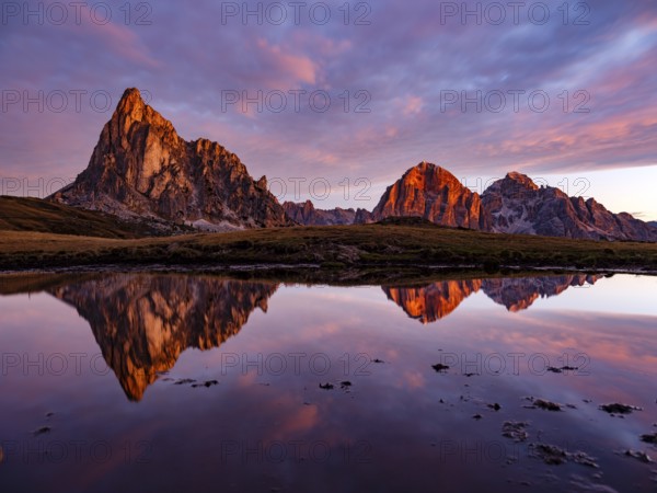 Alpine glow, reflection of the Ra Gusela and Tofane mountains at dawn, Passo di Giau, Giau Pass,
