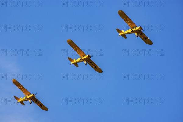 Three Piper PA-18 Super Cub aeroplanes of the Bravo Lima Formation flying in formation during an
