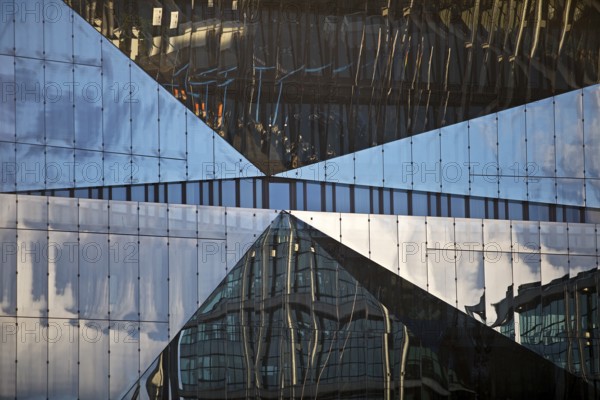 Cube Berlin, cube-shaped office building with folded glass façade reflecting the surroundings,